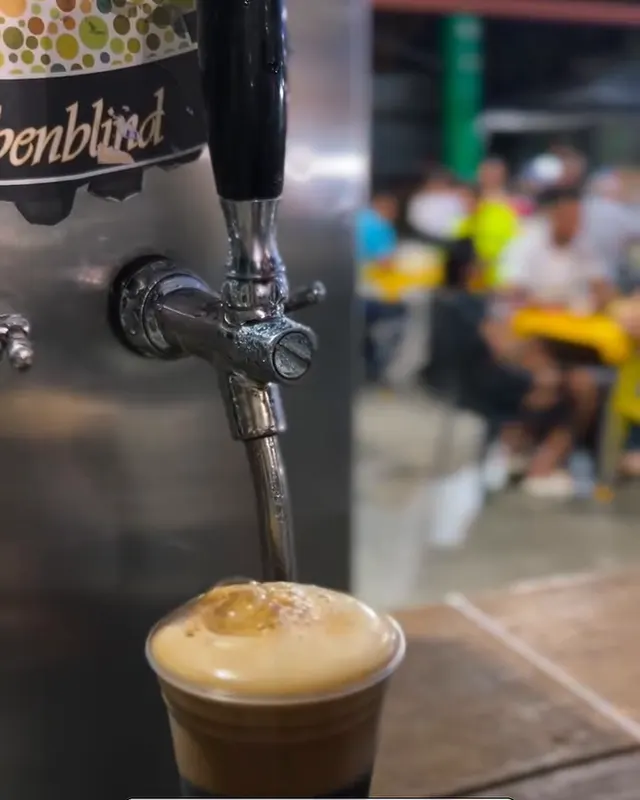 Chopp escuro com espuma cremosa saindo da torneira da Farbenblind